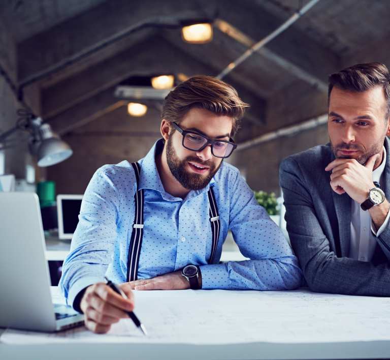 Photo of employees planning on a table